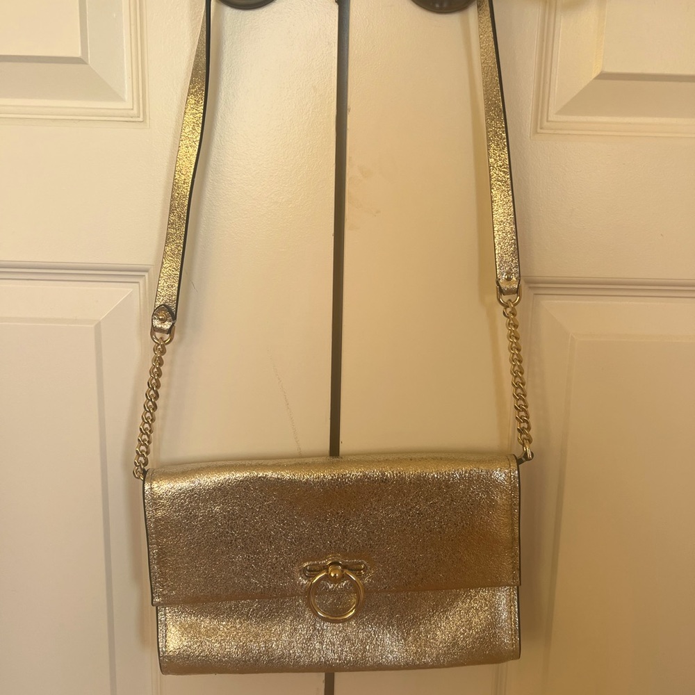 Rebecca Minkoff gold over the shoulder, sleek bag.  10.5” x  1.5” x 6.5”